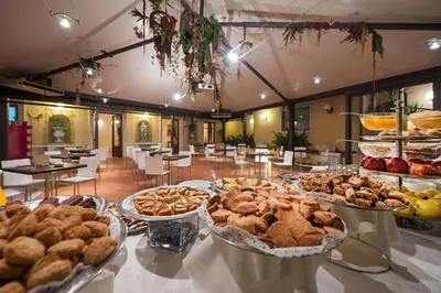 a buffet filled with different types of food on a table at Best Western Ai Cavalieri Hotel in Palermo