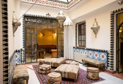a living room with couches and ottomans at Best Western Ai Cavalieri Hotel in Palermo