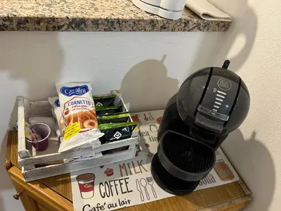 a coffee maker sitting on a table with some food at House Corso Calatafimi in Palermo