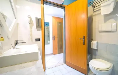 a bathroom with a toilet and a sink and a shower at Mono 2 in Lido di Mondello