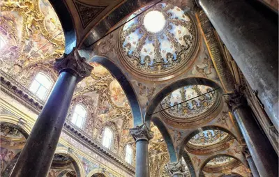 a large building with a ceiling with paintings on it at Mono 2 in Lido di Mondello