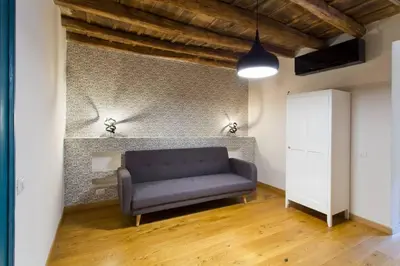 a living room with a blue couch and a wall at Casa del Vinile in Palermo