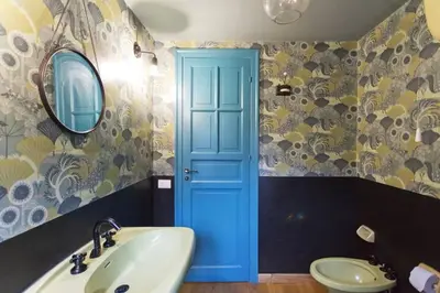 a bathroom with a sink and a blue door at Casa del Vinile in Palermo