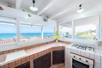 a kitchen with a view of the ocean at HolidaySicily Alcamo Marina in Alcamo Marina