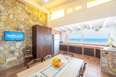 a kitchen with a table with fruit on it at HolidaySicily Alcamo Marina in Alcamo Marina