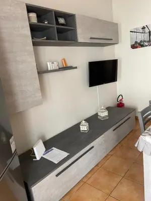 a room with a desk with a tv on a wall at La casa di Angy in Terrasini