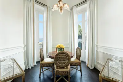 a dining room with a table and chairs and a chandelier at Rocco Forte Villa Igiea in Palermo
