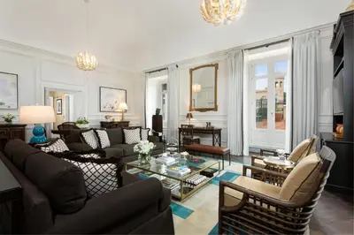a living room with a couch and a table at Rocco Forte Villa Igiea in Palermo