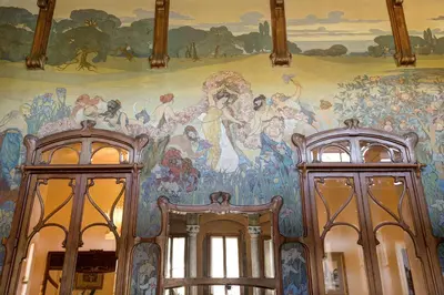 a mural on the wall of a room with two doors at Rocco Forte Villa Igiea in Palermo