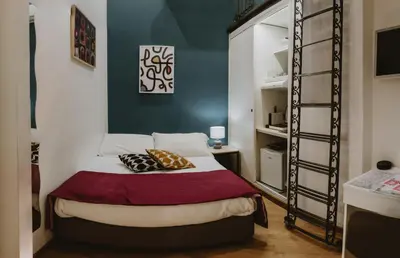 a bedroom with a bed and a ladder at Maravigghia Palermo Rooms in Palermo