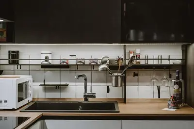 a kitchen with a sink and a microwave at Maravigghia Palermo Rooms in Palermo