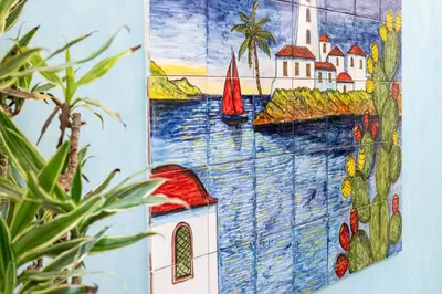 a painting of a building on a wall at Federico 70 Giada Economy in Palermo