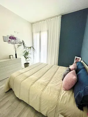 a bedroom with a large bed with pillows on it at Charmrooms in Castellammare del Golfo