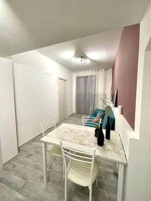 a dining room with a table and chairs at Charmrooms in Castellammare del Golfo