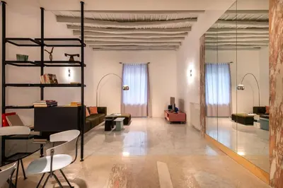 a living room with a couch and chairs at Sartoria Cavour - Modern Sicilian Elegance in a Former Tailor Shop in Palermo