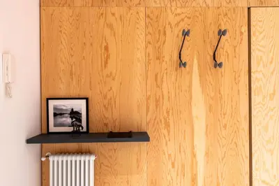 a wall with two blue toothbrushes hanging on it at Sartoria Cavour - Modern Sicilian Elegance in a Former Tailor Shop in Palermo
