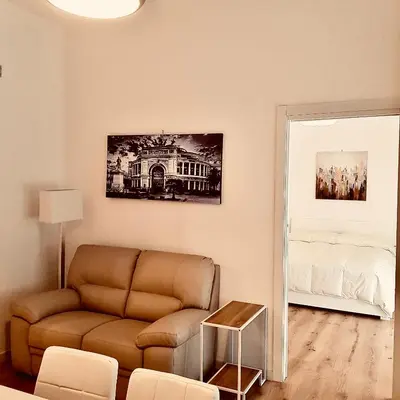 a living room with a couch and a bed at Residence D'azeglio in Palermo