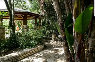 a garden with a stone walkway and a pavilion at RESIDENCE FEDERICA in Castellammare del Golfo