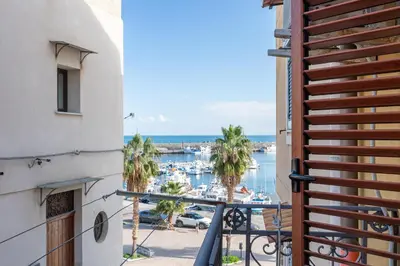 a balcony with a view of a marina at Solemar Sicilia - Principe del Mare in Santa Flavia