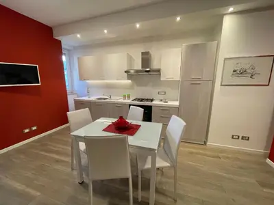 a kitchen with a white table and white chairs at Wagner House in Palermo