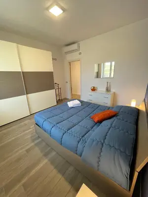 a bedroom with a large blue bed in a room at Wagner House in Palermo