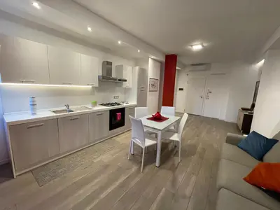 a kitchen and living room with a table and a couch at Wagner House in Palermo