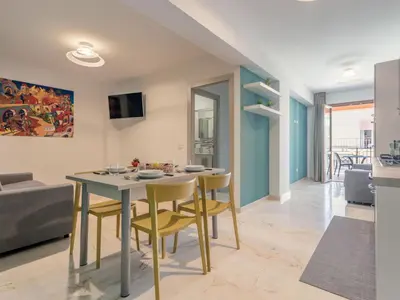 a dining room and living room with a table and chairs at Apartment Palermo by Interhome in Balestrate