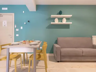 a dining room with a table and a couch at Apartment Palermo by Interhome in Balestrate