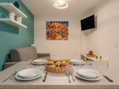 a table with plates and a basket of fruit on it at Apartment Palermo by Interhome in Balestrate