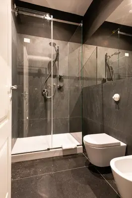 a bathroom with a shower and a toilet and a sink at Carlo Suite Apartments con Vasca Idromassaggio in Palermo