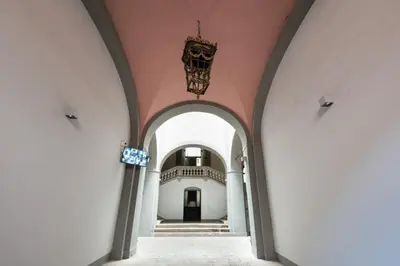 a hallway of a building with a chandelier at Carlo Suite Apartments con Vasca Idromassaggio in Palermo