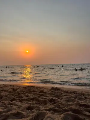 people in the water at the beach at sunset at A-marè - CasaVacanza in Trappeto