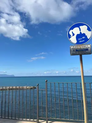 a sign in front of a body of water at A-marè - CasaVacanza in Trappeto