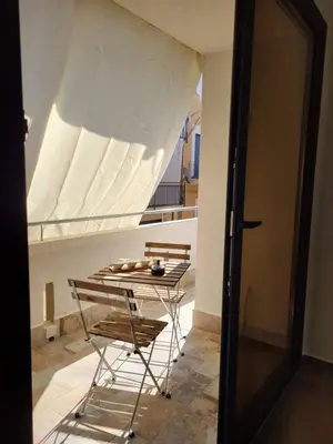a table and chairs in a room with a window at A-marè - CasaVacanza in Trappeto