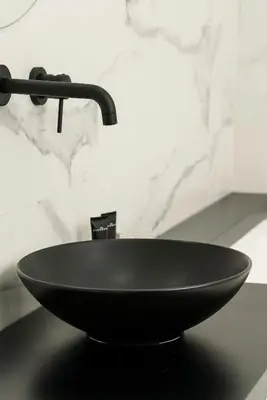 a black sink with a faucet on a counter at Marmur Suite in Palermo