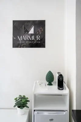 a white refrigerator with a sign on the wall at Marmur Suite in Palermo