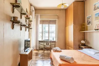 a bedroom with a bed and a television and a table at Le stanze di Nonna Maria in Palermo