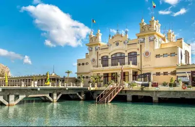 a building on a pier next to the water at Le stanze di Nonna Maria in Palermo