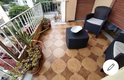 a balcony with two chairs and a table and a floor at Le stanze di Nonna Maria in Palermo