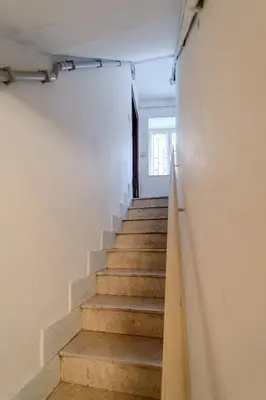 a stairway leading up to a room with white walls at Casetta Holiday Meli in Palermo