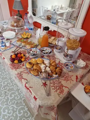 a table with many plates of food on it at Corallo Rosso B&B in Terrasini