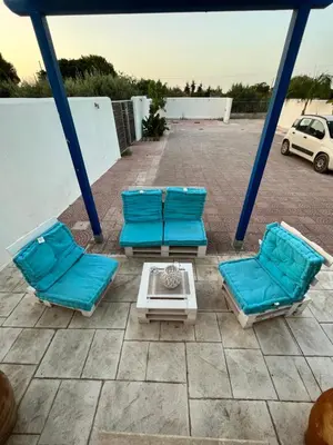 a group of blue lounge chairs on a patio at B&B Santorini in Cinisi