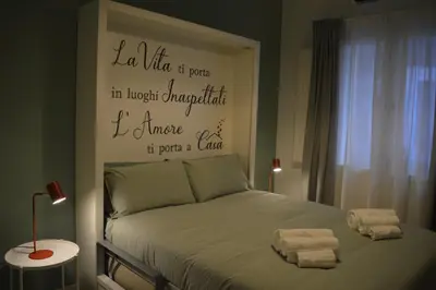 a bedroom with a bed with towels on it at Arco Cutò casa vacanze in Palermo