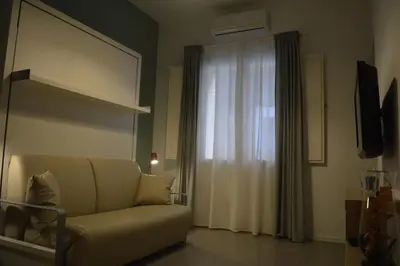 a living room with a couch and a window at Arco Cutò casa vacanze in Palermo