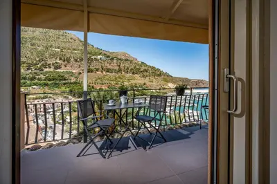 a balcony with a table and chairs and a view at Suite Altamarea 