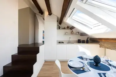 a dining room with a table and chairs and a skylight at Kalsa Skyhome in Palermo