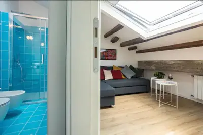 a living room with a couch and a shower at Kalsa Skyhome in Palermo