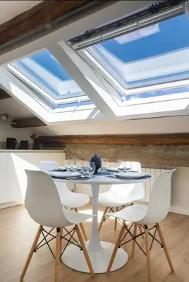 a dining room with skylights and a table and chairs at Kalsa Skyhome in Palermo