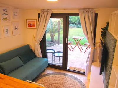 a living room with a couch and a sliding glass door at Cozy Suite&Lodge Mondello beach in Palermo