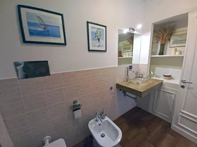 a bathroom with a sink and a toilet at Cozy Suite&Lodge Mondello beach in Palermo